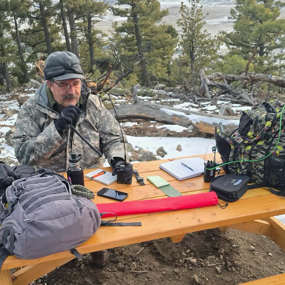 Hiker using a handheld radio in the mountains